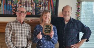 Dave Michel and Ed Petty presenting a 10 year service award to Lisa Barnett 